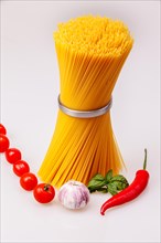 Spaghetti standing with fresh spices and vegetables