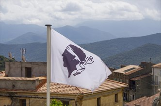 Corsican flag flying in a village in the Corsican mountains