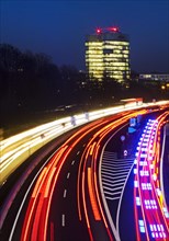 Light trails on the A 52 motorway and the E.ON SE corporate headquarters in the evening