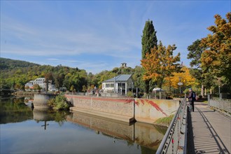 Spa park on the river Nahe in autumn and view of tea temple on the Kauzenberg