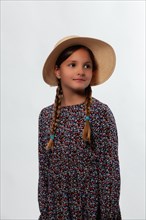 Portrait of a young girl wearing a sun hat