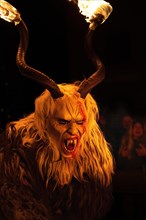 Klausen mask with burning horns in the dark