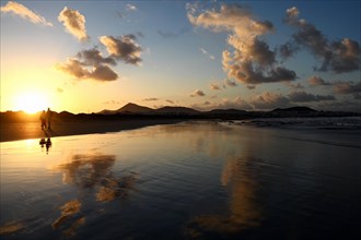 Sunset reflected on Caleta de Famara beach