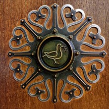 Fitting on the door to the Peace Hall with dove of peace