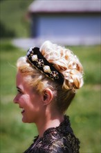 Blonde woman in lace dress with hairband and curly hair