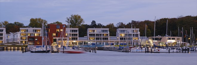 Marina and illuminated modern buildings