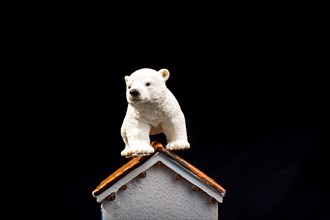 Polar bear model placed on a model house