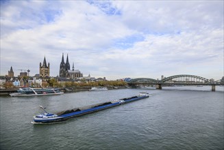 View from Deutzer Bruecke over the Rhine to the Rhine bank at Leystapel with coal freighter