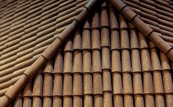 Traditional roof covered with brown tiles made of wood