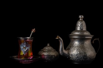 Tea glass with teapot and metal sugar bowl