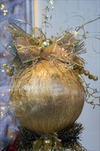 Merry Christmas with golden decorative ball in view