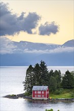 Typical red house on the island of Omaholmen in Hardangerfjord
