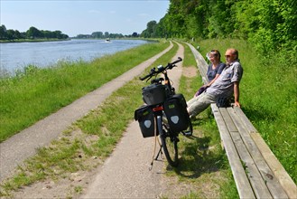 Couple sitting on the world's longest bench on the Kiel Canal