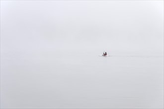 Kayakers in dense fog on Lake Diemel