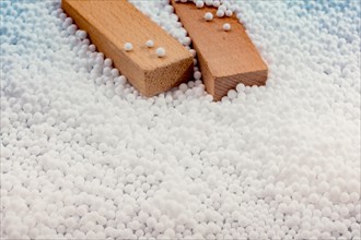 Wooden blocks in White polystyrene foam balls as background
