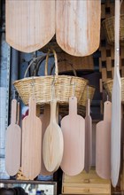 Wooden chopping boards and straw baskets hanging on display