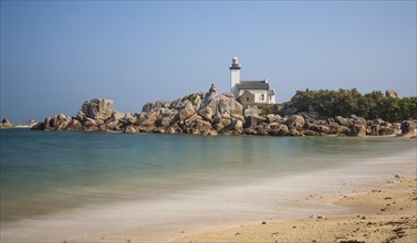 Phare de Pontusval lighthouse on granite rocks on sandy beach Plage du Phare