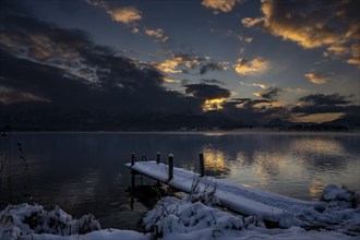 Hopfensee with Steeg and cloudy sky at blue hour