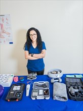 Physiotherapist with physiotherapy accessories. Smiling physiotherapist showing physiotherapy accessories