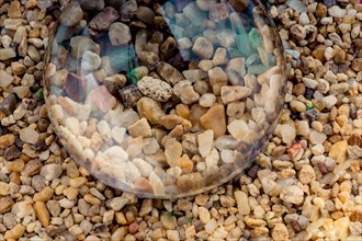 Little gravel stones as a background under a glass