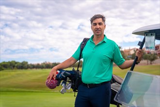 Portrait of a caucasian man playing golf next to the buggy on a cloudy day