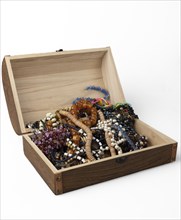 Opened wooden box with colourful bead jewellery