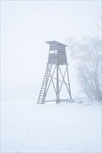 High seat in the fog with snow
