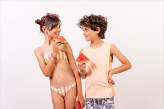Children eating a watermelon in the summer heat