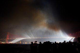 Crowd watch fireworks show over the Istanbul City View of Bosporus Bridge