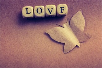 Butterfly cut of paper and love wording in view