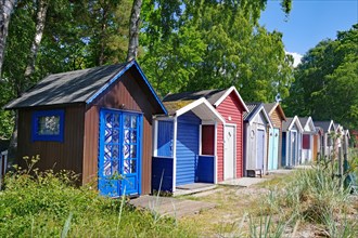 Small beach huts in bright colours