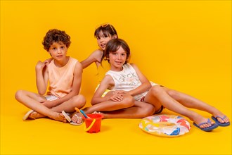 Children sitting on the floor enjoying summer vacation