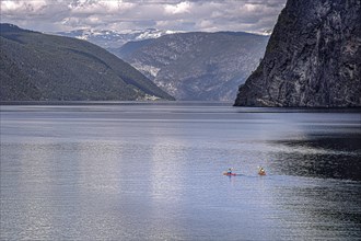Two kayak riders paddle on the Aurlandsfjord in Norway
