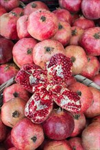 Cut pomegranate in Turkish street bazaar in the view