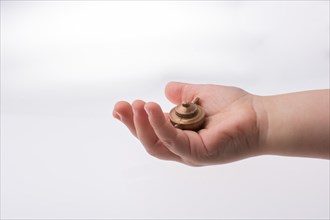 Toddler holding a miniature bronze teapot in the view