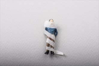 Tiny figurine of man miniature model wrapped in bandages