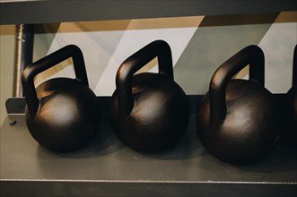 Steel gym kettles on metal stand in the view