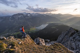 Hiker at the summit of Schartschrofen at sunset