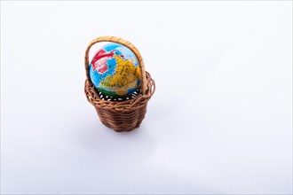 Little model globe in a basket in view