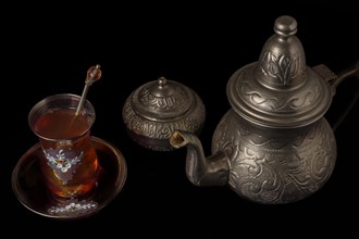 Tea glass with teapot and metal sugar bowl