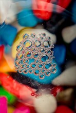 Colorful water bubbles on a glass ground in view