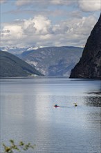 Two kayakers paddle on the Geiranger Fjord in Norway