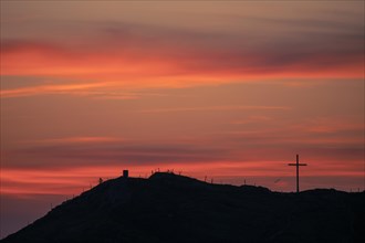 Mountain ridge with summit cross at sunrise