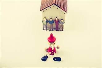 Tiny figurine of men and puppet pinocchio model in view