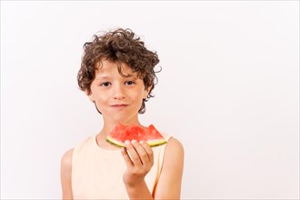 Boy enjoying the summer eating a watermelon