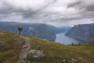 Two woman look from the mountain over the Aurlandsfjord in Norway
