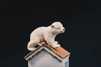 Polar bear model placed on a model house