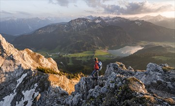 Hiker at the summit of Schartschrofen at sunset