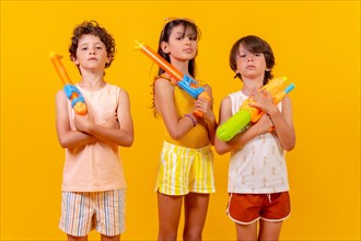 Children with water pistols on summer vacation