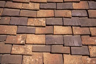 Tiled roof made of handmade tiles as texture or background